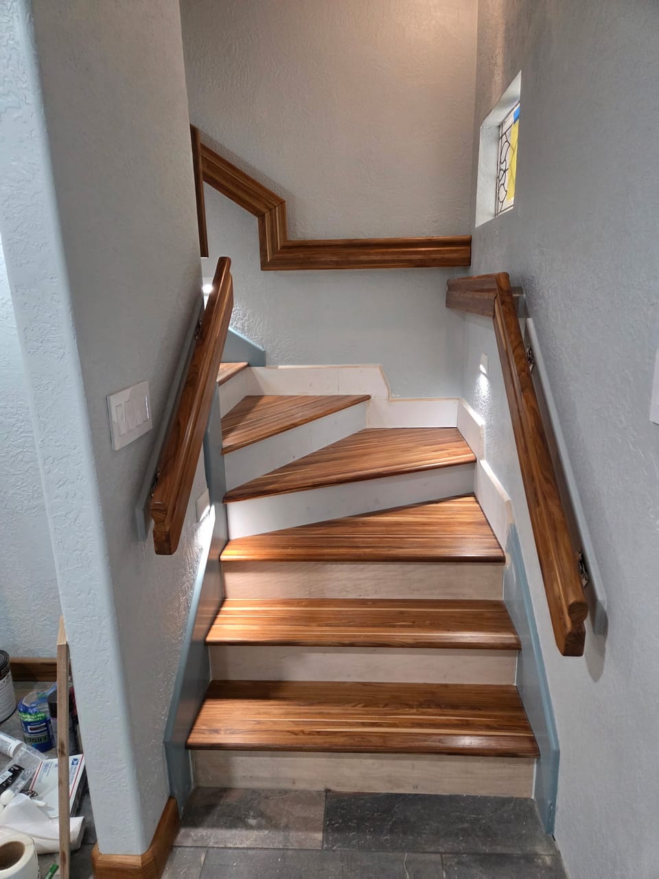 Winder staircase with walnut handrails